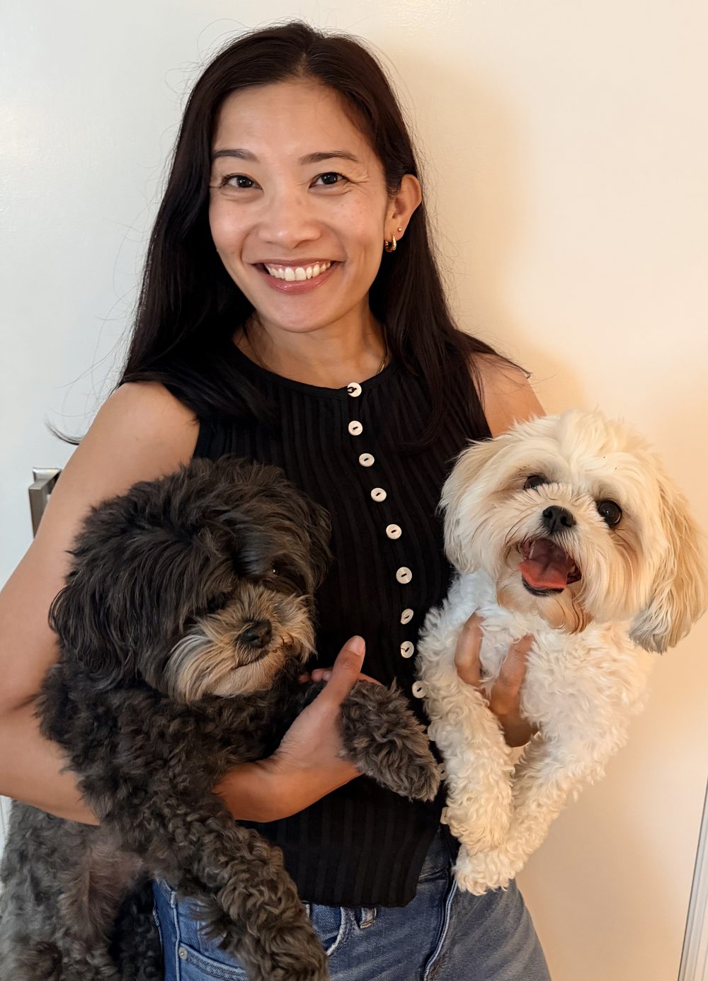 Farah Grainger smiling, holding her two dogs